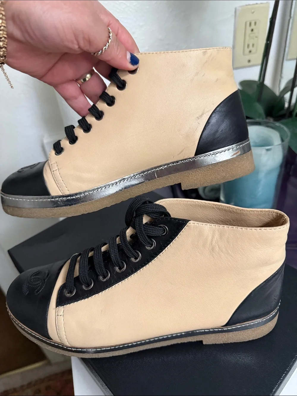 CHANEL Two-Tone Leather High-Top Sneakers in Beige & Black